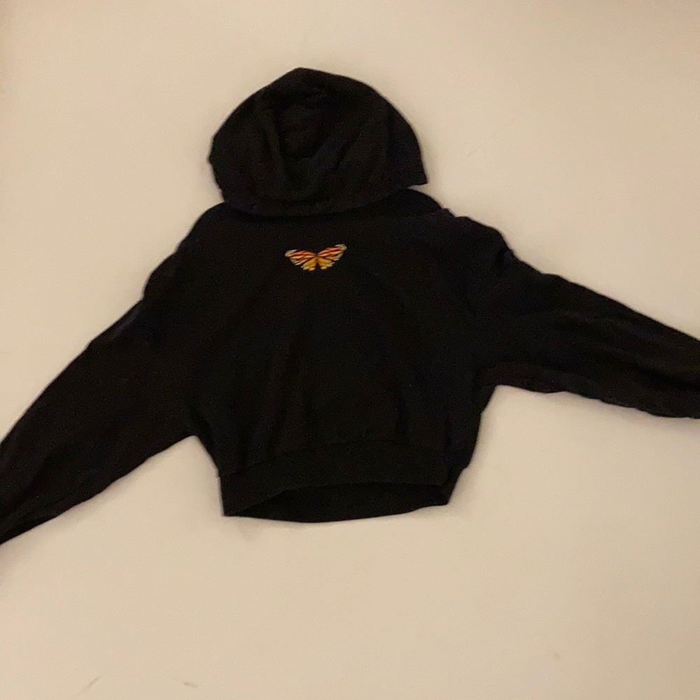 Cropped black butterfly sweater.